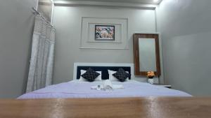 a bedroom with a large bed with a mirror at Staeg Rudraa in Ujjain