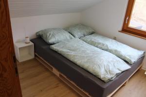 a bed with two pillows on it in a room at Naturzauber in Sonnenbühl