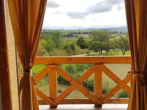 an open window with a view of a field at Brujas in Los Reartes
