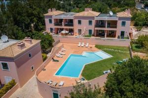 an aerial view of a large house with a swimming pool at Sunny Haven Alvor in Alvor