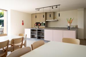a kitchen and dining room with tables and chairs at Le Petit Fief in Couvin