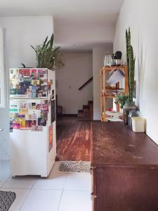 a kitchen with a refrigerator and a table at Casa Antiga em OP in Ouro Preto