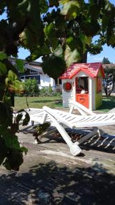 a white bench with a dog house on it at Villa Mary in Venegono Superiore +16 photos