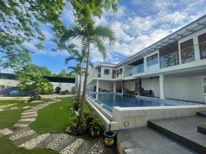 an exterior view of a house with a swimming pool at Caloocan Private Resort in Manila