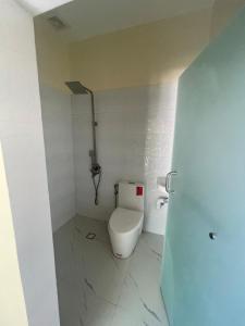 a small bathroom with a toilet in a room at Caloocan Private Resort in Manila +27 photos