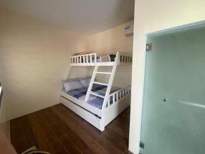 a bunk bed with a ladder in a room at Caloocan Private Resort in Manila
