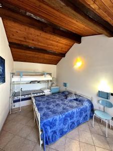 a bedroom with a bed and a wooden ceiling at DANY HOME - Casa Vacanze Andora in Moltedo