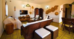 a living room with a couch and a television at Casa aconchegante na praia in Peruíbe +22 photos