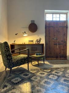a living room with a chair and a table at Casa Manamunda in San Vero Milis +28 photos