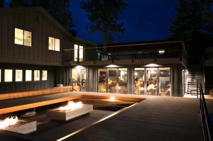 a house with a deck and a fire pit at night at The Coachman Hotel in South Lake Tahoe