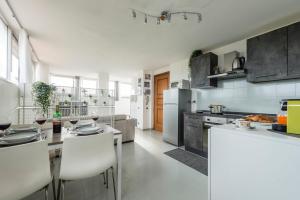 a kitchen with white appliances and a table and chairs at Casa di Eva in Pisa