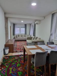 a living room with a table and a couch at Happy House in Sarajevo +48 photos