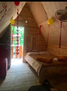 a bedroom with a bed in a log cabin at Centro vacacional cabañas irenita in Pradera