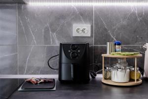 a coffee maker on a counter in a kitchen at HeyYou Apartment in Bjelovar