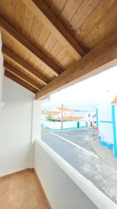 a view from the balcony of a building with a wooden ceiling at SWEET HOME Milfontes in Vila Nova de Milfontes