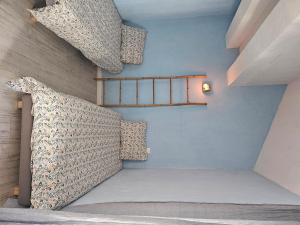 a room with a bed and a shelf on the wall at Appartement sur le port in Saint-Florent