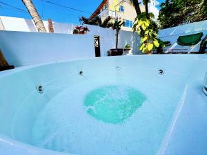 a bath tub filled with blue water next to a fence at Auaecoco Hotel in Cartagena de Indias