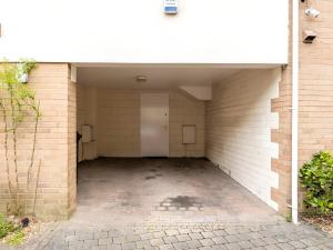 a garage with a white door and a brick wall at Modern 4-Level Townhouse for 8 Free Parking Bournemouth in Bournemouth +21 photos