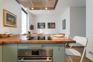 a kitchen with a counter and a stove top oven at Ciliegio in Pavia dʼUdine
