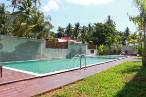 a swimming pool in a resort with a wooden deck at Crystal Lamai Hotel in Lamai