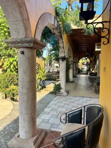 a building with a bench in the middle of a street at Casa de Alegria in Lo de Marcos