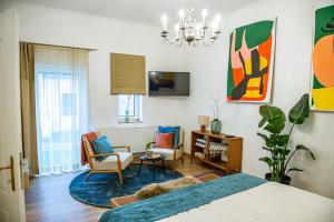 a bedroom with a bed and chairs and a desk at MAG Premium Residence Sopron in Sopron