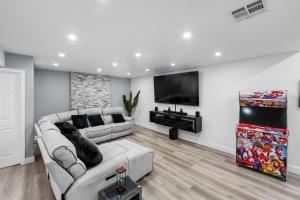a living room with a couch and a flat screen tv at Spacious 4-bedroom Glendora Super House in Glendora