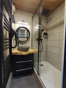 a bathroom with a sink and a mirror at Residence La Vanoise - Appartement chaleureux ski aux pieds in Val Thorens +17 photos