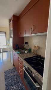 a kitchen with a sink and a stove top oven at Estartit Jardins del mar 51 in L'Estartit +22 photos