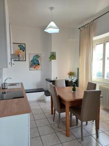 a kitchen and dining room with a wooden table and chairs at M&M Apartment in Ponte Lucano +14 photos