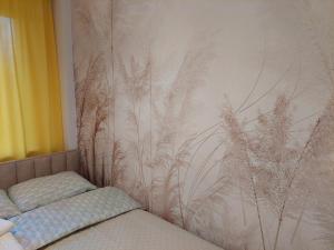 a bedroom with a wall mural of tall grass at Apartament Kaszmir in Sandomierz +28 photos