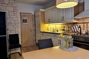 a kitchen with a table with a vase of flowers on it at Ferienhaus Inge in Stolberg