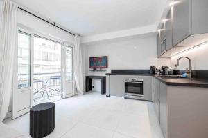 a kitchen with a sink and a counter top at La suite Versailles Croisette in Cannes