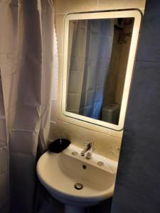 a bathroom with a sink and a mirror at Aquarium Seaview accomodations in Hurghada