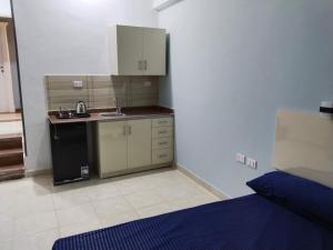 a small kitchen with a sink and a refrigerator at Aquarium Seaview accomodations in Hurghada