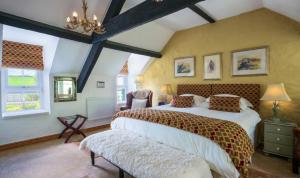 a bedroom with a large bed in a room at Yr Hen Felin - The Old Mill B&B in Morfa Nefyn