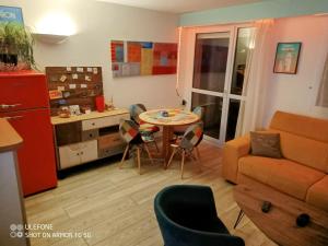 a kitchen and living room with a table and a couch at Studio au cœur de Quiberon in Quiberon