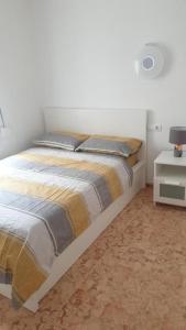 a bedroom with a bed and a table with a lamp at SunandSea in L'Estartit