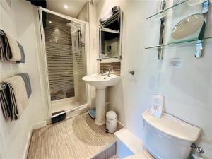a small bathroom with a sink and a toilet at Yr Hen Felin - The Old Mill B&B in Morfa Nefyn