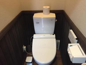 a toilet with a roll of toilet paper on top of it at Ryokan Yufusan in Yufu +22 photos