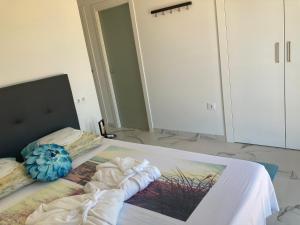 a bedroom with a bed with a large mirror at micasa in Denia +12 photos