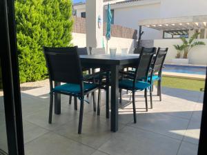 a black table and chairs on a patio at micasa in Denia
