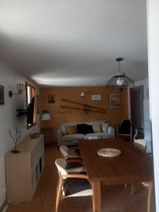 a living room with a table and a couch at La soulane in Ax-les-Thermes +7 photos