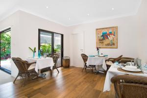 a dining room with two tables and chairs at Cronulla Beach House B&B in Cronulla +31 photos