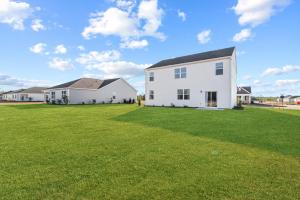 a large white house with a large yard at Luxury 5BR Home Near Beaches & Downtown Wilmington in Scotts Hill