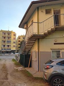 a staircase on the side of a building with a car at Estensi 14 in Lido degli Estensi