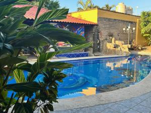 a swimming pool at a resort with blue water at Casa de Alegria in Lo de Marcos +2 photos