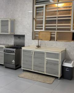 a kitchen with a sink and a stove and cabinets at Asayl resort in Baghdad