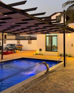 a swimming pool in a house with a building at Asayl resort in Baghdad