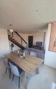 a dining room with a wooden table and chairs at Hermoso moderno Duplex en El Sur de Cali in Cali